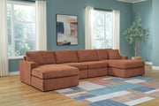 Ashley Furniture Modmax sectional with chaise, featuring modern upholstery and spacious seating in a stylish living room setting.