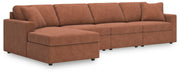 Ashley Furniture Modmax sectional with chaise, featuring plush fabric upholstery and modern design in a spacious living room setting.