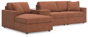 Ashley Furniture Modmax sectional with chaise, featuring plush cushions and modern design in a spacious living room setting.