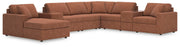 Ashley Furniture Modmax sectional with chaise, featuring plush cushions and modern design, shown in a cozy living room setting.