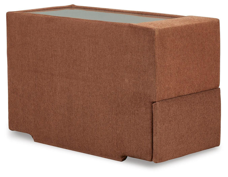 Ashley Furniture Modmax balanced sectional with built-in audio, storage consoles, and a modern design, viewed from an angle.