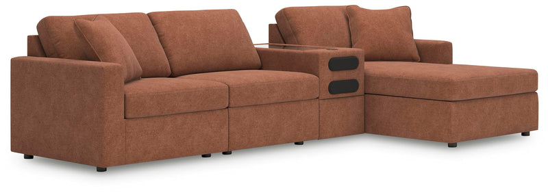 Ashley Furniture Modmax sectional with chaise, showcasing a modern fabric sofa with a spacious chaise lounge in a stylish living room setting.
