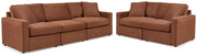 Ashley Furniture Modmax living room set with sofa, loveseat, and armchair in a modern design, shown in a cozy living space.
