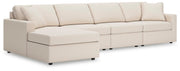 Ashley Furniture Modmax sectional with chaise, featuring plush cushions and modern design in a spacious living room setting.