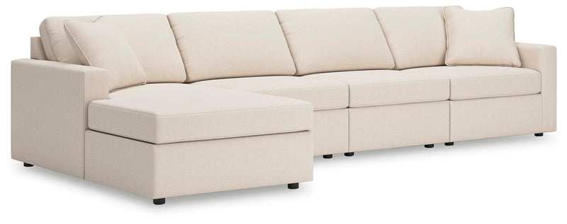 Ashley Furniture Modmax sectional with chaise, featuring plush cushions and modern design in a spacious living room setting.
