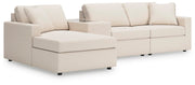 Ashley Furniture Modmax sectional with chaise, featuring plush cushions and modern design in a neutral fabric.