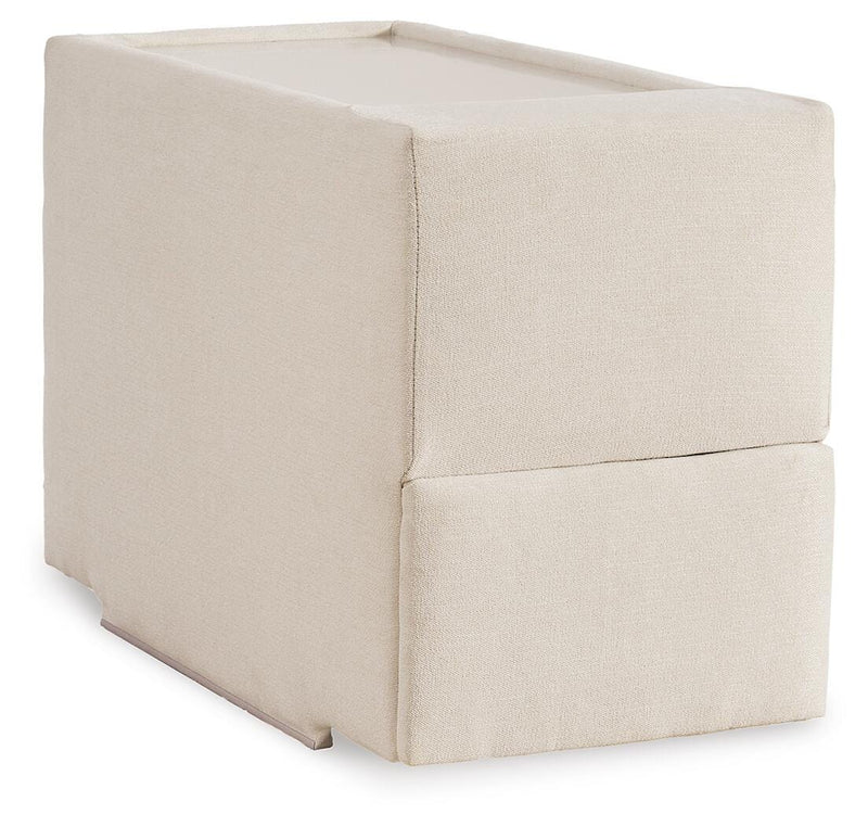 Ashley Furniture Modmax sectional with built-in audio and storage consoles, shown from an angled view, featuring modern design and fabric upholstery.