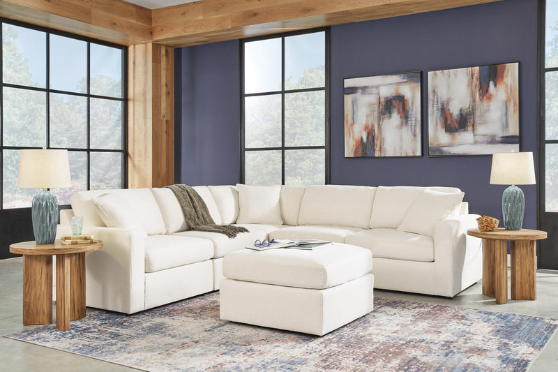 Ashley Furniture Modmax living room set featuring a sofa, armchair, and coffee table in a modern design with neutral upholstery.