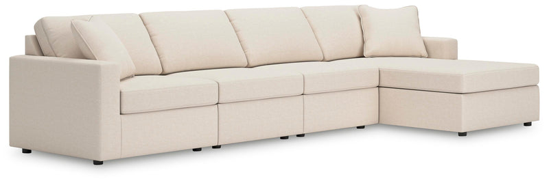 Ashley Furniture Modmax sectional with chaise, featuring plush cushions and modern design, shown in a spacious living room setting.