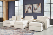 Ashley Furniture Modmax living room set with sofa and armchair in a modern design, featuring neutral upholstery and stylish cushions.
