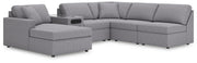 Ashley Furniture Modmax sectional with chaise, featuring modern design, plush cushions, and fabric upholstery in a stylish living room setting.