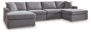 Ashley Furniture Modmax sectional with chaise, featuring plush upholstery and modern design in a stylish living room setting.