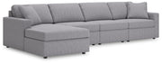 Ashley Furniture Modmax sectional with chaise, featuring modern fabric upholstery and stylish angled design, shown from a side angle.
