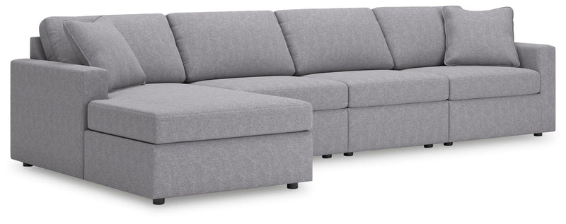 Ashley Furniture Modmax sectional with chaise, featuring modern fabric upholstery and stylish angled design, shown from a side angle.