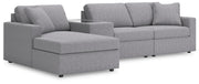 Ashley Furniture Modmax sectional with chaise, showing a modern fabric sofa with a spacious chaise lounge in a contemporary living room setting.