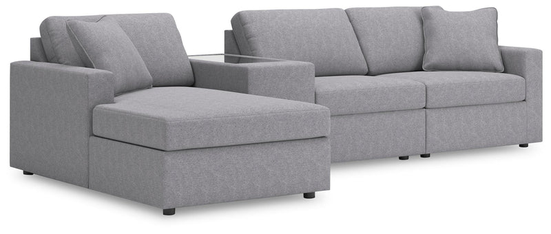 Ashley Furniture Modmax sectional with chaise, showing a modern fabric sofa with a spacious chaise lounge in a contemporary living room setting.