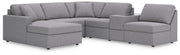 Ashley Furniture Modmax sectional with chaise, featuring plush cushions and modern design, shown in a stylish living room setup.