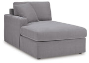 Ashley Furniture Modmax sectional with chaise, featuring plush fabric and modern design, shown in an angled view.
