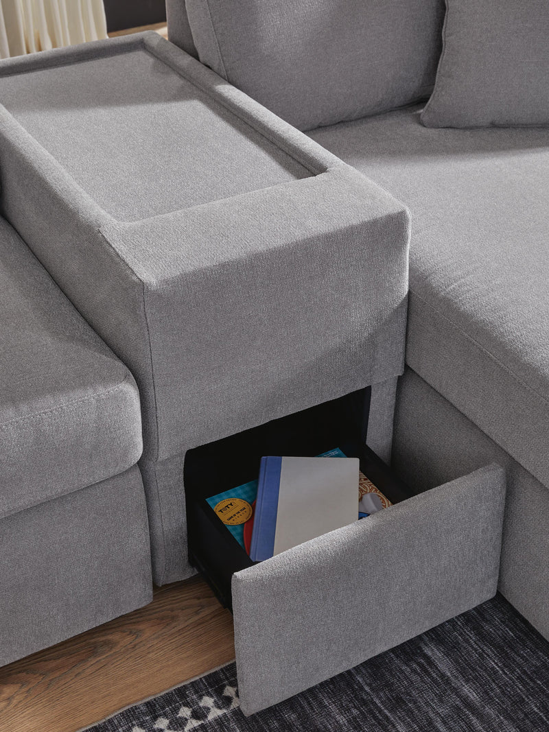 Close-up of Ashley Furniture Modmax sectional with chaise, highlighting the sectional's console detail and modern upholstery design.