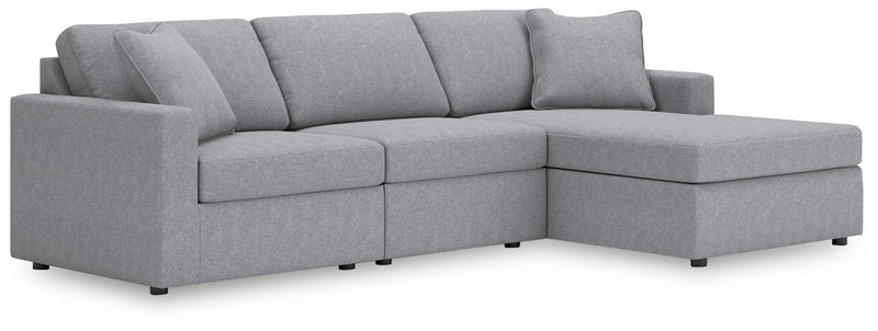 Ashley Furniture Modmax sectional with chaise, showing modern upholstered sectional sofa with chaise lounge in a living room setting.