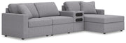Ashley Furniture Modmax sectional with chaise, featuring plush fabric upholstery and modern design in a spacious living room setting.
