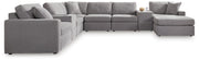 Ashley Furniture Modmax sectional with chaise, featuring modern design and plush cushions in a stylish living room setting.