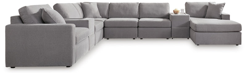Ashley Furniture Modmax sectional with chaise, featuring modern design and plush cushions in a stylish living room setting.