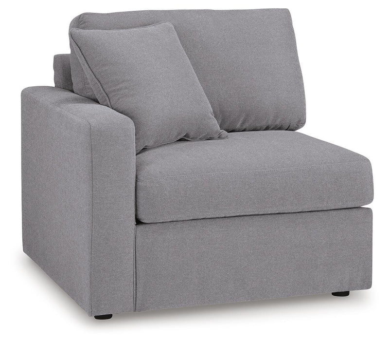 Ashley Furniture Modmax sectional with built-in audio and storage consoles, shown from an angled view in a modern living room setting.
