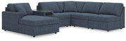 Ashley Furniture Modmax sectional with chaise, showing modern fabric upholstery and spacious design in a living room setting.