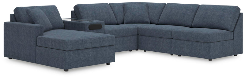 Ashley Furniture Modmax sectional with chaise, showing modern fabric upholstery and spacious design in a living room setting.