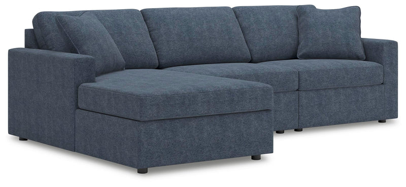 Ashley Furniture Modmax sectional with chaise, featuring modern design and plush upholstery in a stylish living room setting.