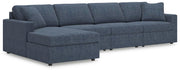 Ashley Furniture Modmax sectional with chaise, showing a modern gray fabric sofa with a built-in chaise lounge and clean design.
