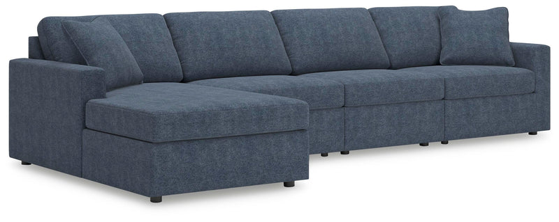 Ashley Furniture Modmax sectional with chaise, showing a modern gray fabric sofa with a built-in chaise lounge and clean design.