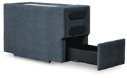 Ashley Furniture Modmax balanced sectional with built-in audio and storage consoles, angled view showing cushions and modern design.