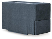 Ashley Furniture Modmax sectional with built-in audio and storage consoles, shown from an angle in a modern living room setting.
