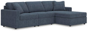 Ashley Furniture Modmax sectional with chaise, showing modern fabric upholstery and spacious seating in a contemporary living room setting.