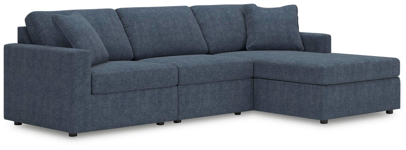 Ashley Furniture Modmax sectional with chaise, showing modern fabric upholstery and spacious seating in a contemporary living room setting.