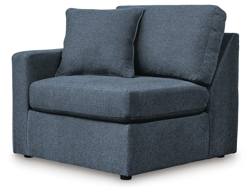 Ashley Furniture Modmax sectional with built-in audio and storage consoles, shown from an angled view in a modern living room setting.