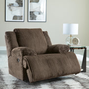 Open Ashley Furniture Top Tier Recliner showing plush cushioned seat and backrest with reclining footrest in a cozy living room setting.