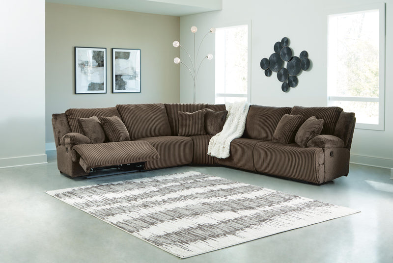 Ashley Furniture Top Tier living room set with sofa, armchair, and coffee table arranged in a modern living space.