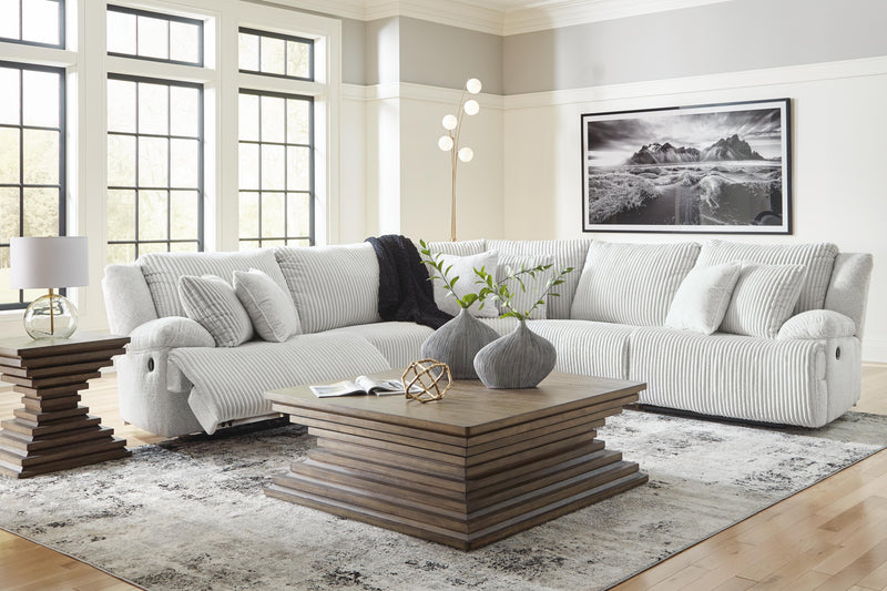 Ashley Furniture Top Tier reclining sectional sofa with plush cushions and reclining seats, shown in a modern living room setting.