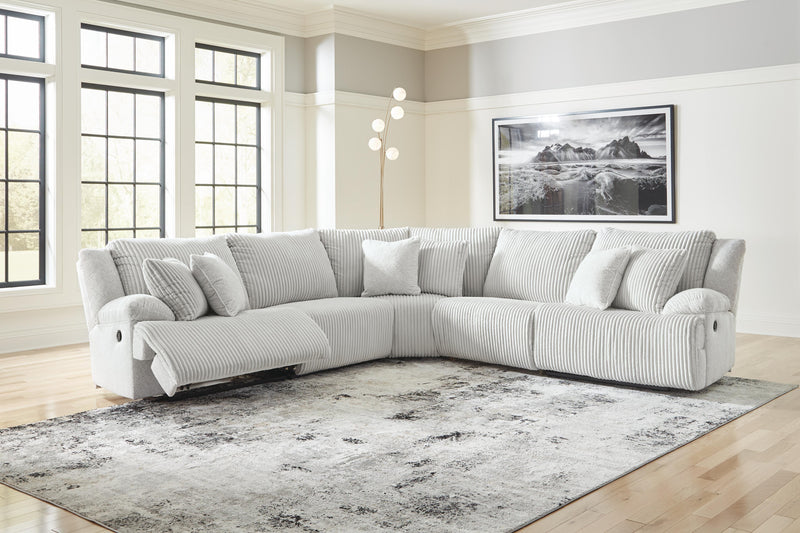Ashley Furniture Top Tier reclining sectional sofa with plush cushions and modern design, shown in a living room setting.
