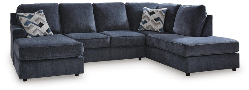 Ashley Furniture Albar Place sectional sofa with plush cushions and neutral fabric, showcasing a modern living room setup.