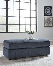 Ashley Furniture Albar Place oversized accent ottoman with plush fabric and modern design, shown in a living room setting.