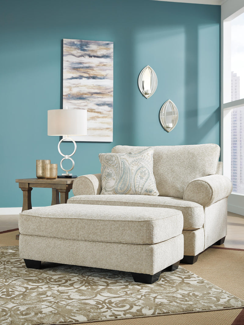 Ashley Furniture Monaghan Oversized Chair with plush fabric and wide armrests, shown in a cozy living room setting.