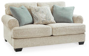Ashley Furniture Monaghan living room set with sofa and armchair, stylish cushions, in a modern home setting.