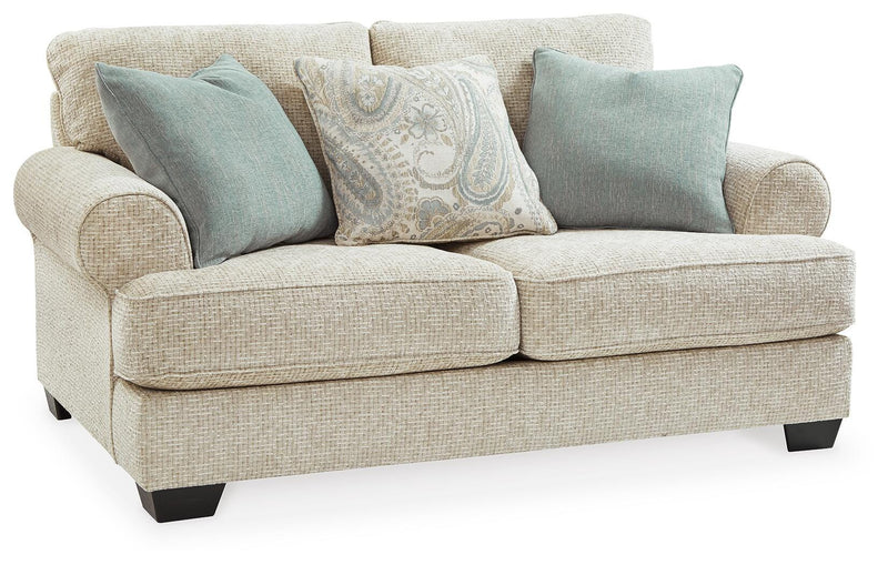 Ashley Furniture Monaghan living room set with sofa and armchair, stylish cushions, in a modern home setting.