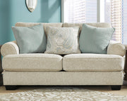 Ashley Furniture Monaghan living room set featuring a sofa and armchair with neutral upholstery and modern design.