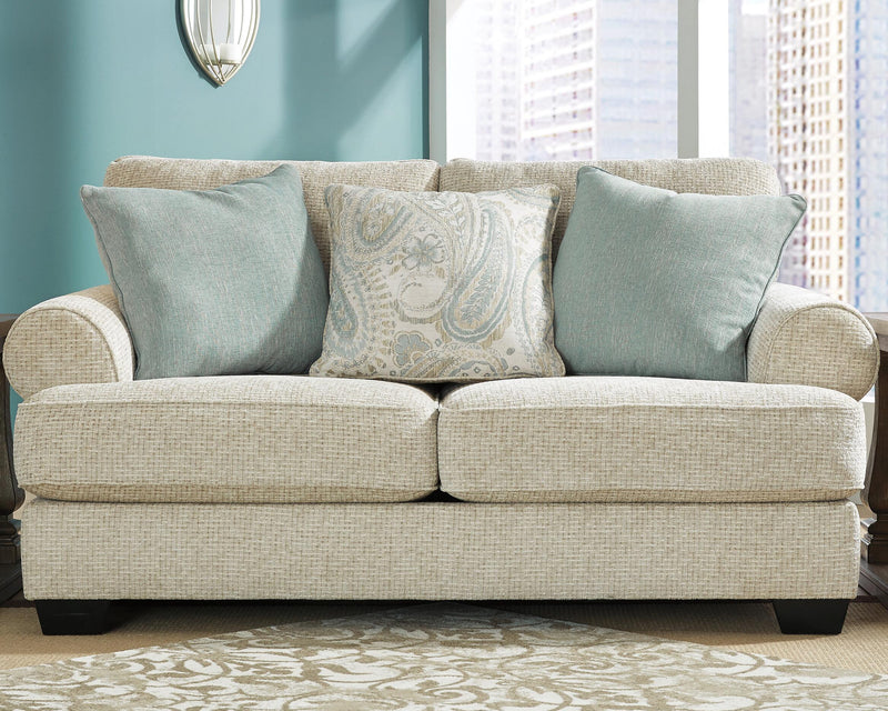 Ashley Furniture Monaghan living room set featuring a sofa and armchair with neutral upholstery and modern design.