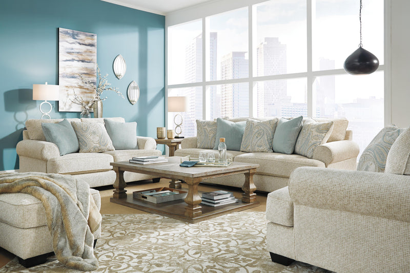 Ashley Furniture Monaghan living room set with sofa and armchair, featuring neutral upholstery and wooden legs.